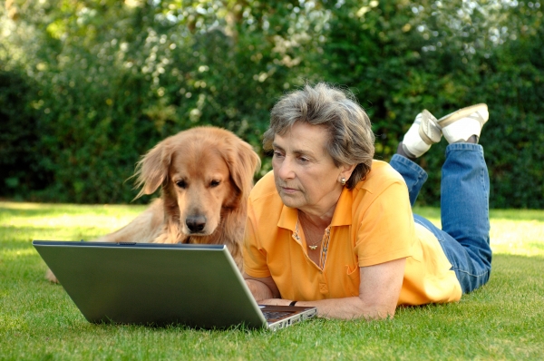 senior woman with dog on laptop