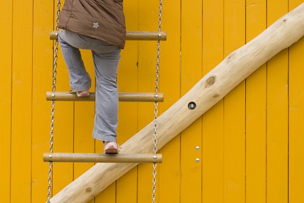 rope ladder against yellow wooden wall