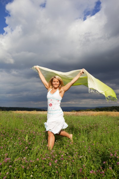 happy woman running with a towel