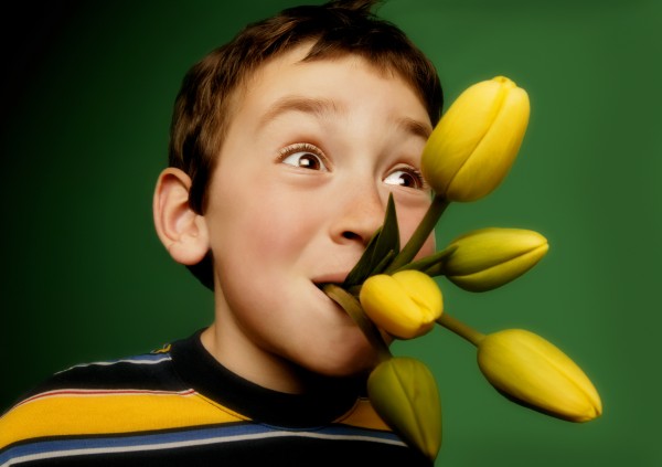 boy with flowers in his mouth
