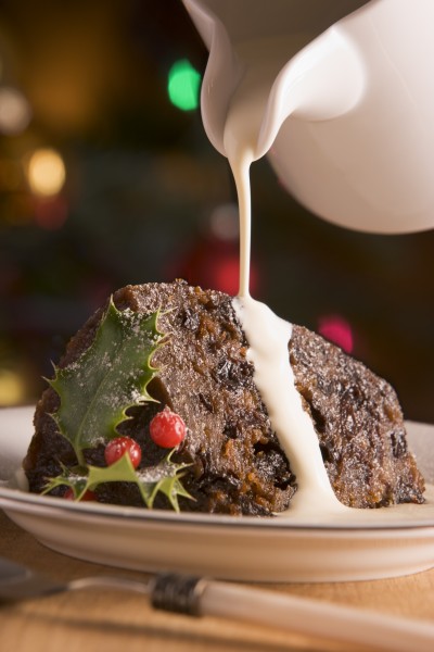 portion of christmas pudding with pouring