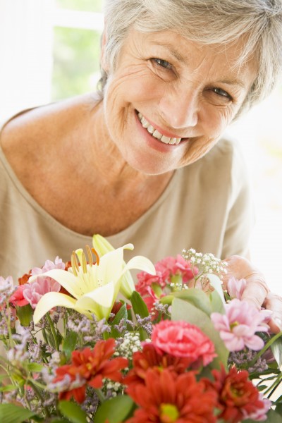 woman with flowers smiling