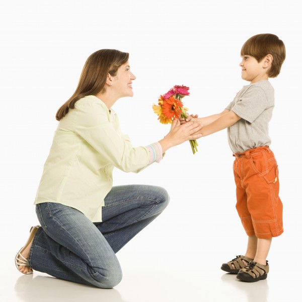 boy giving mother flowers