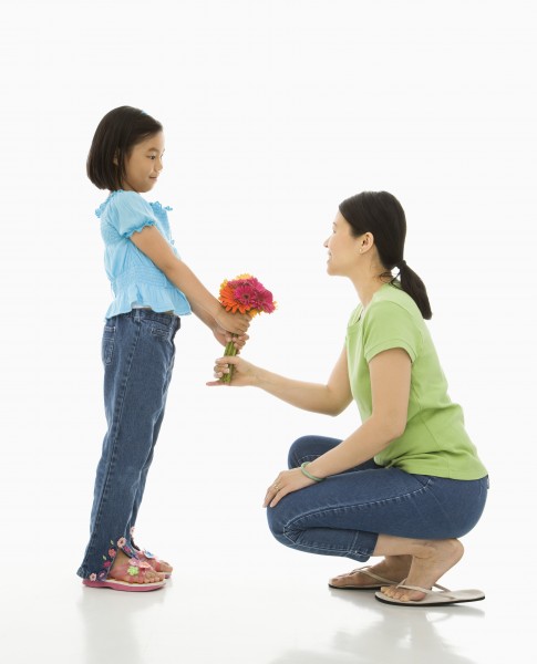 girl giving mother flowers