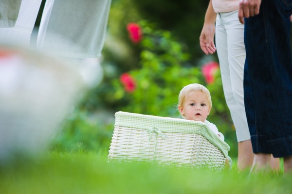 child sitting outside in a white