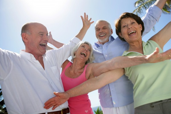 happy group of seniors by raising