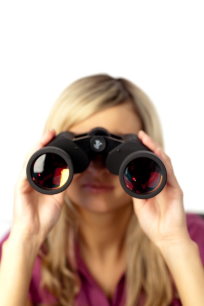delighted woman using binoculars