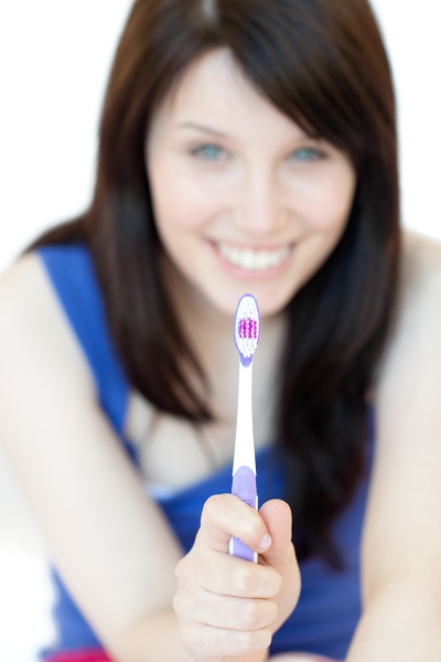 pretty woman holding a toothbrush