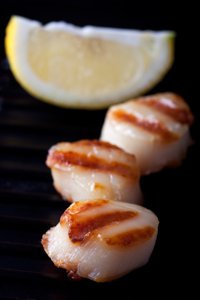 close up of two grilled scallops