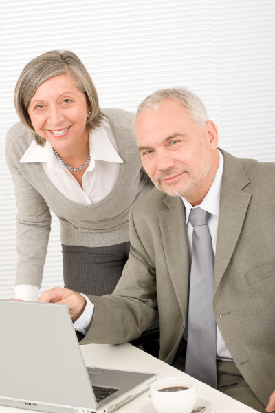 senior businesspeople in office work on