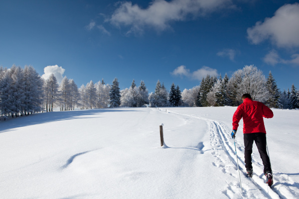 young man cross country skiing on
