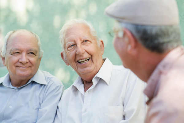 group of happy elderly men laughing