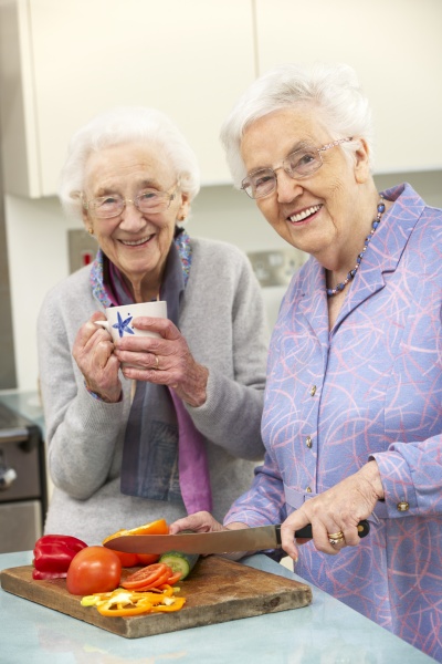 senior women preparing meal together