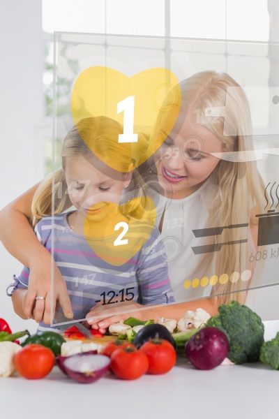 mother and daughter chopping vegetables with