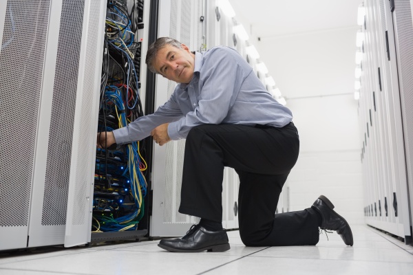 man fixing server wires