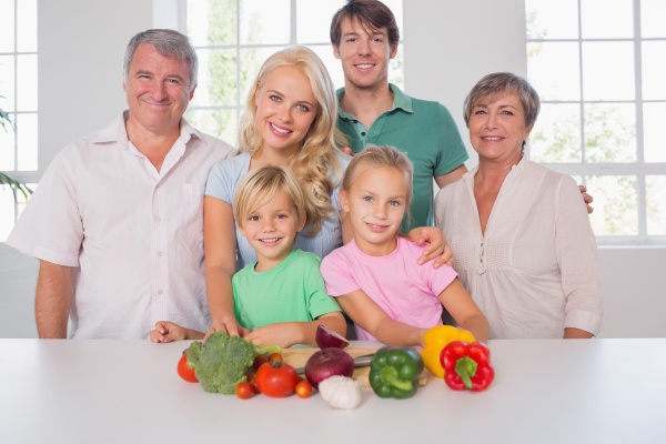 family smiling with vegetables