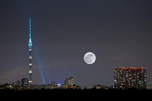 full moon under city