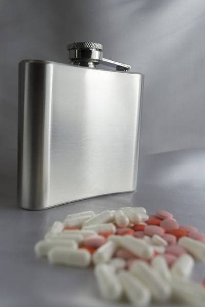 silver flask and pills