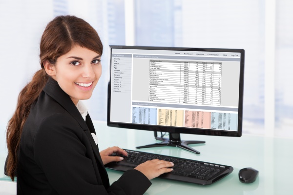 confident businesswoman using computer at desk