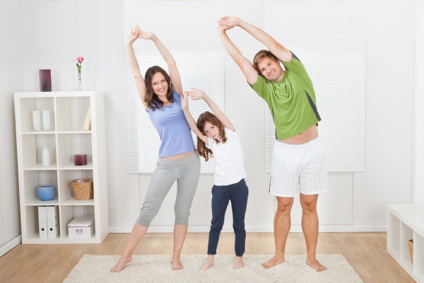 portrait of fit family performing yoga