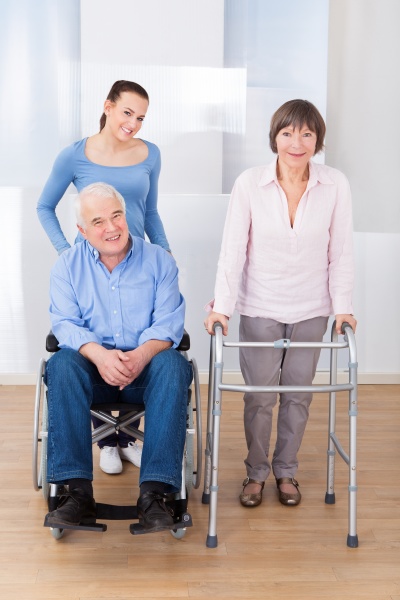 disabled senior couple with caregiver