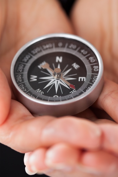 businessperson holding compass