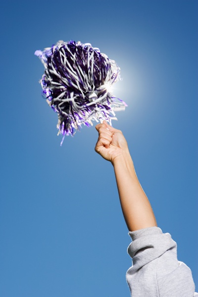 arm of a cheerleader holding pom
