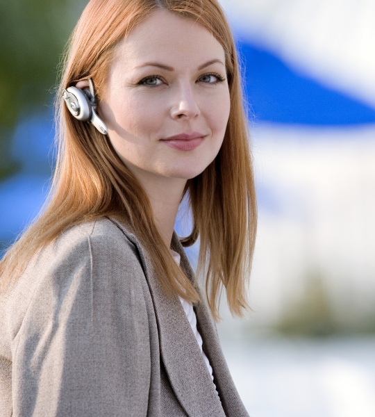 businesswoman wearing mobile phone hands free