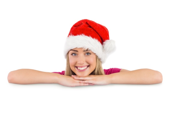festive blonde leaning on large poster