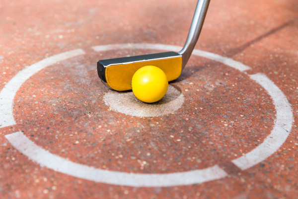 miniature golf club with ball at
