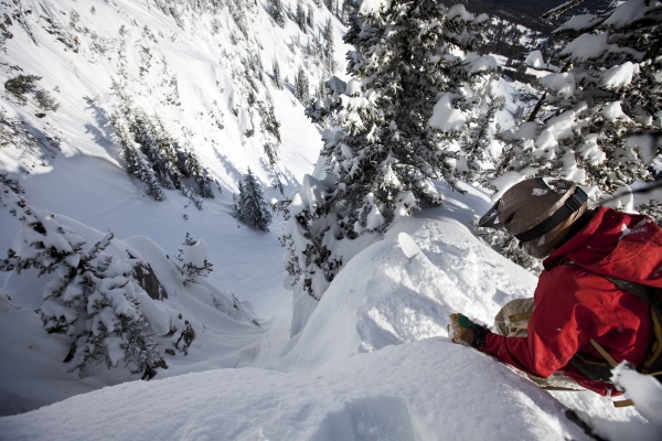a telemark skier scouts his line