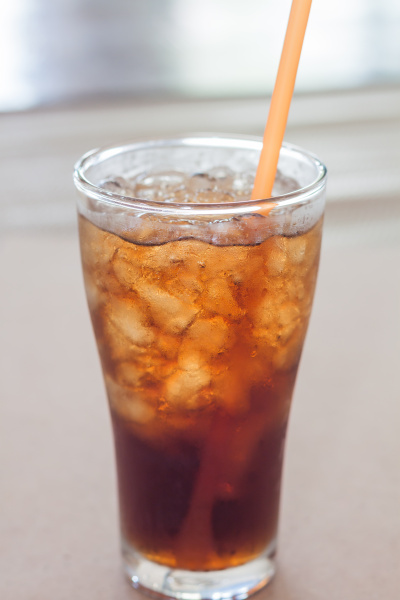 a glass of cola with ice