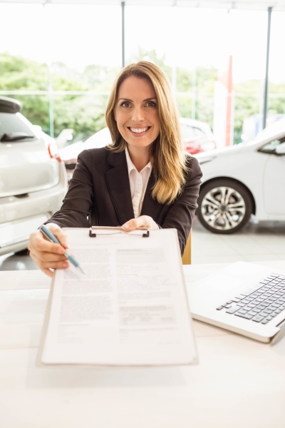 smiling saleswoman holding a clipboard
