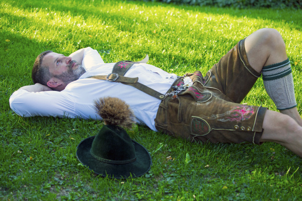 bavarian man lying on the grass