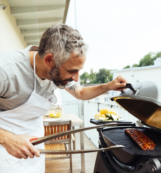 man barbecuing on his balcony