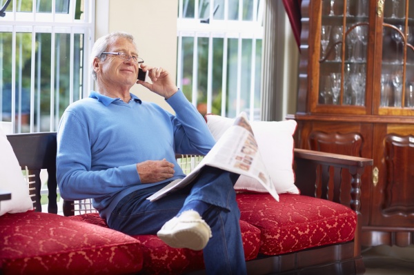 senior man on the phone reading