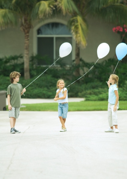 suburban children holding balloons
