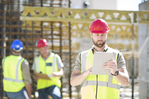 construction worker using digital tablet in
