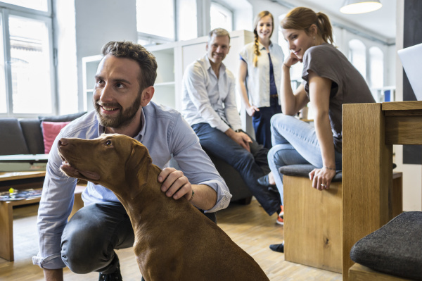 colleagues with dog in office