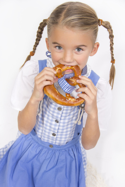 portrait of little girl eating pretzel