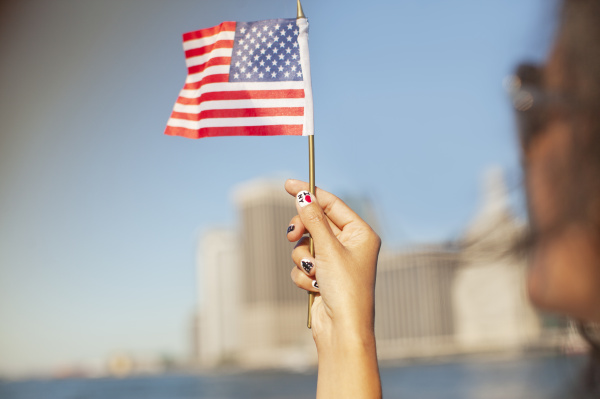 woman with novelty nails waving american