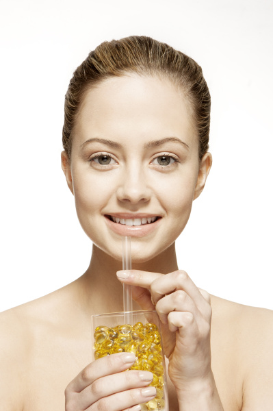 woman drinking glass of vitamins