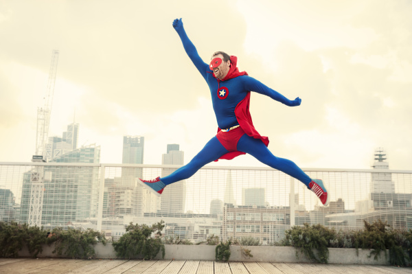 superhero jumping on city rooftop