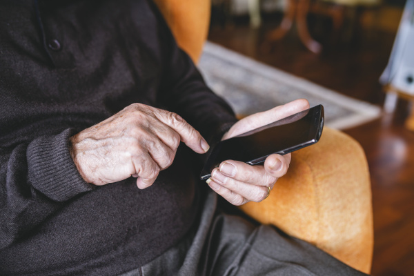 hands of senior man using smartphone