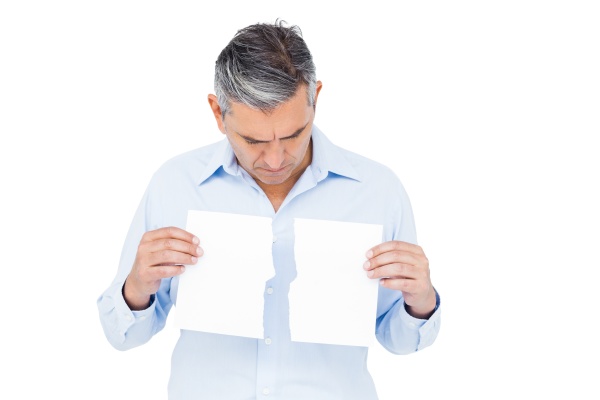man holding torn white paper