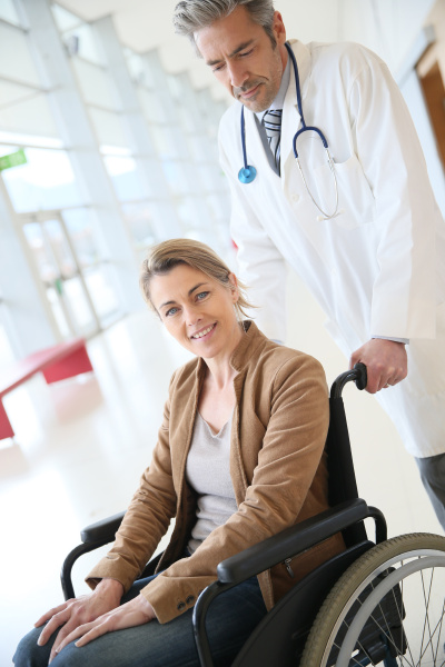 doctor talking to woman in wheelchair