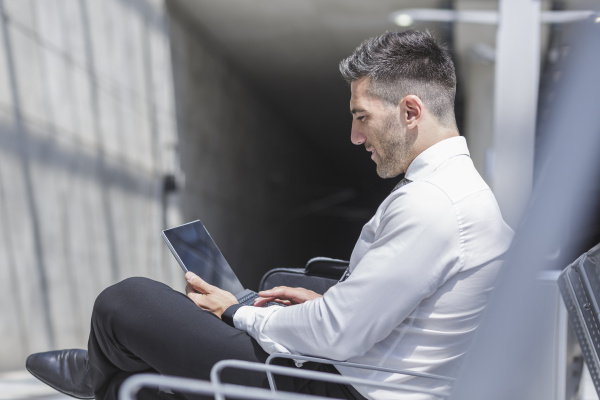 businessman using digital tablet at waiting