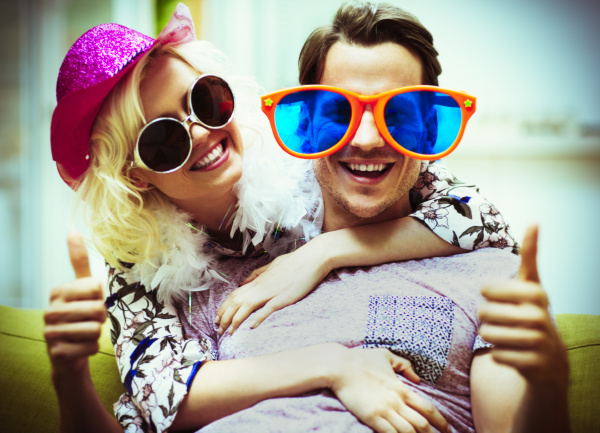 portrait playful couple wearing costume sunglasses