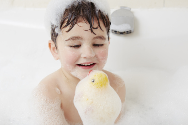 boy in bath with bubbles on