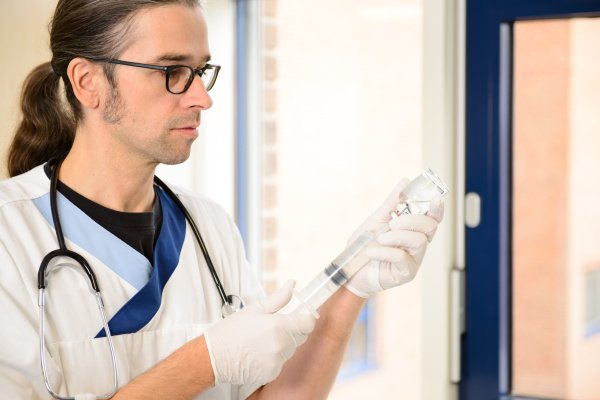 male nurse prepare a liquid medicament
